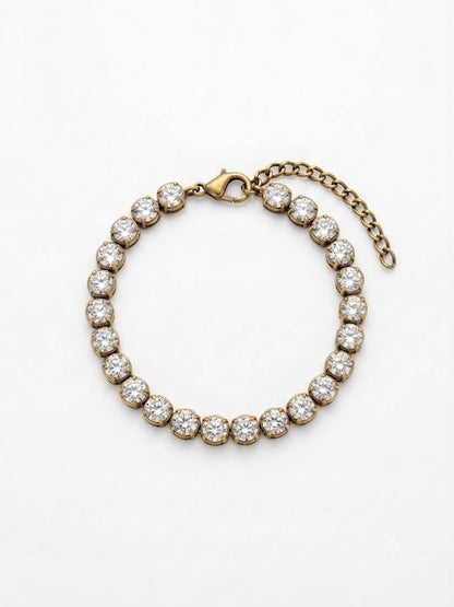 Vintage Solitaire tennis bracelet flat lay — antique gold, hand-set cubic zirconia, lobster clasp with extender